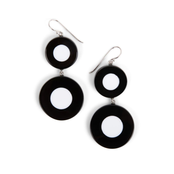 A pair of black and white dot pattern drop earrings made of resin, attached to sterling silver hooks.