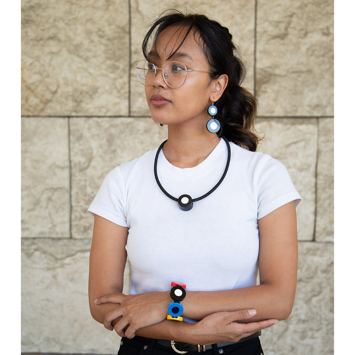 Model wearing french dot necklace, bracelet, and earrings