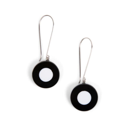 A pair of long wire earrings with black and white beads, isolated on a white background.