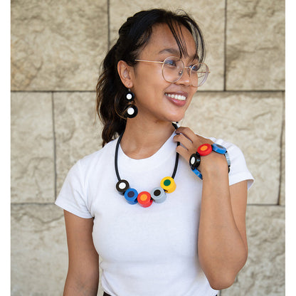 Model wearing french dot necklace, bracelet, and earrings