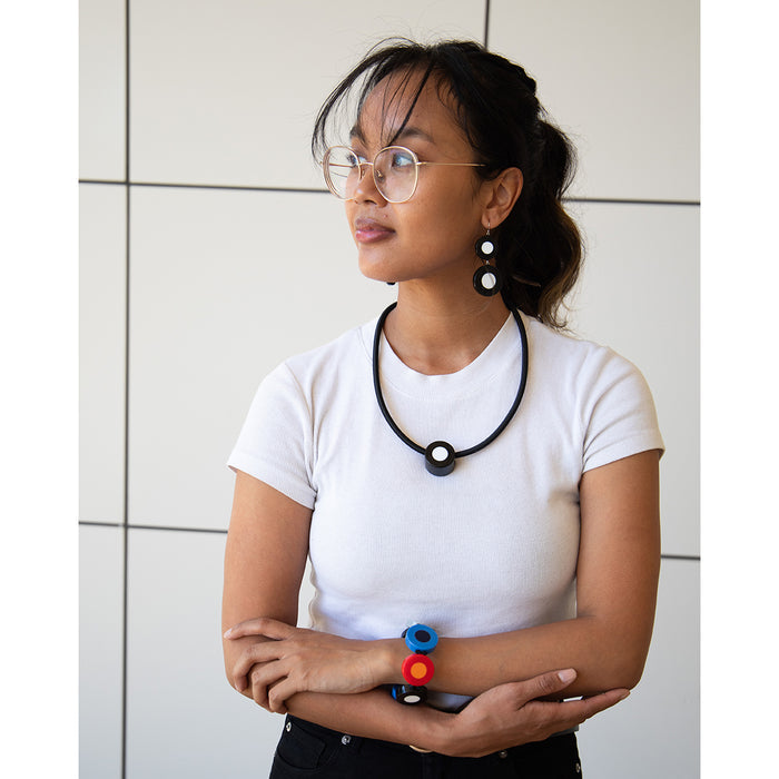 Model wearing french dot jewelry, earrings, and bracelet