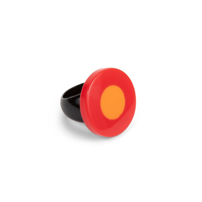 A ring with a red and orange flattened bead on a resin base, with a black band.