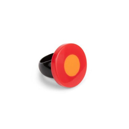 A ring with a red and orange flattened bead on a resin base, with a black band.