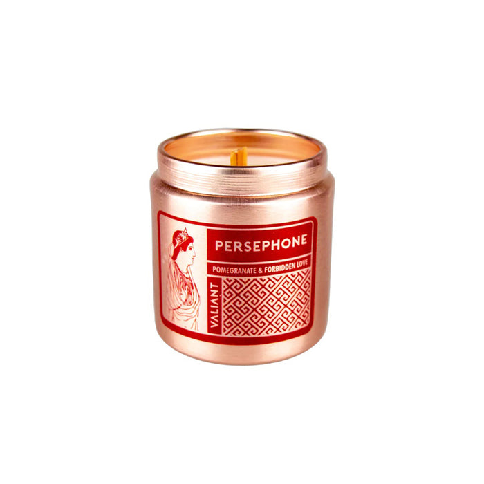 A bronze-colored candle vessel labeled 'PERSEPHONE' with an image of a woman scented with Pomegranate & Forbidden Love