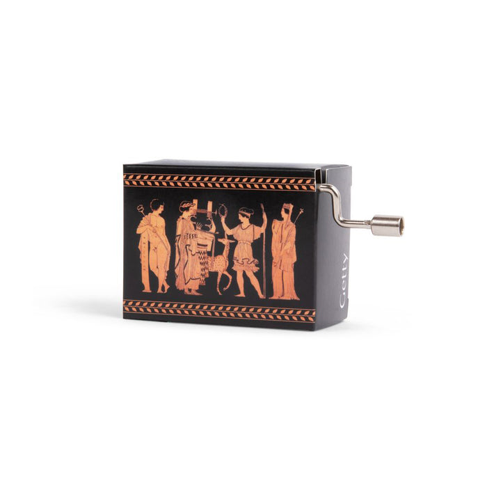 A music box with a red and black design featuring a classical figure scene, with a hand crank on the side.